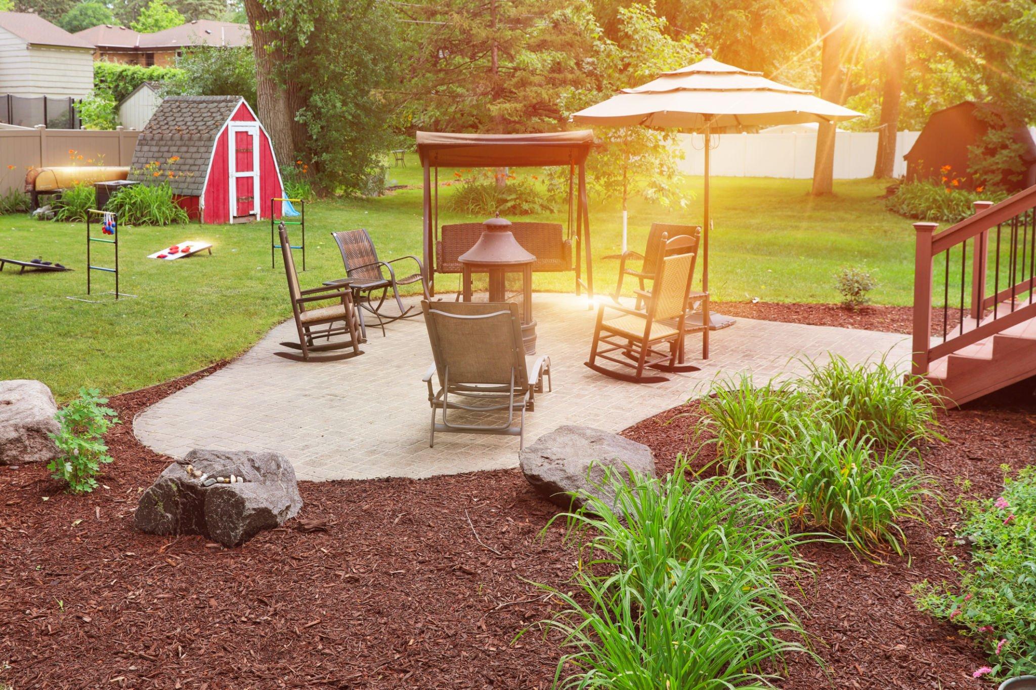 Mulch around patio space with plants for a simple garden in Midlothian, VA